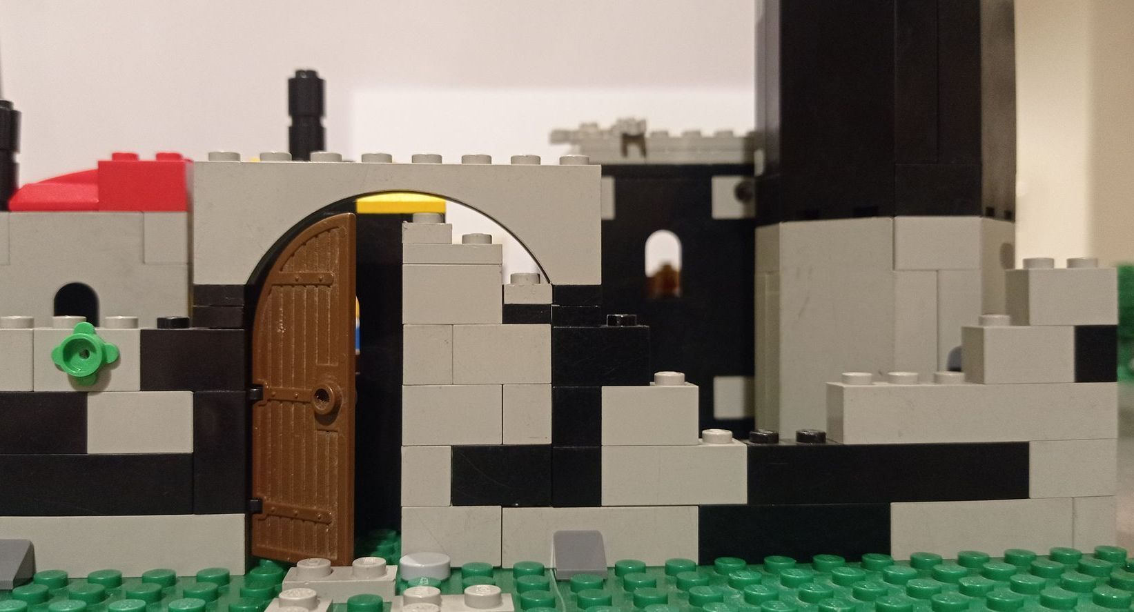 A castle made out of lego bricks with a wooden door