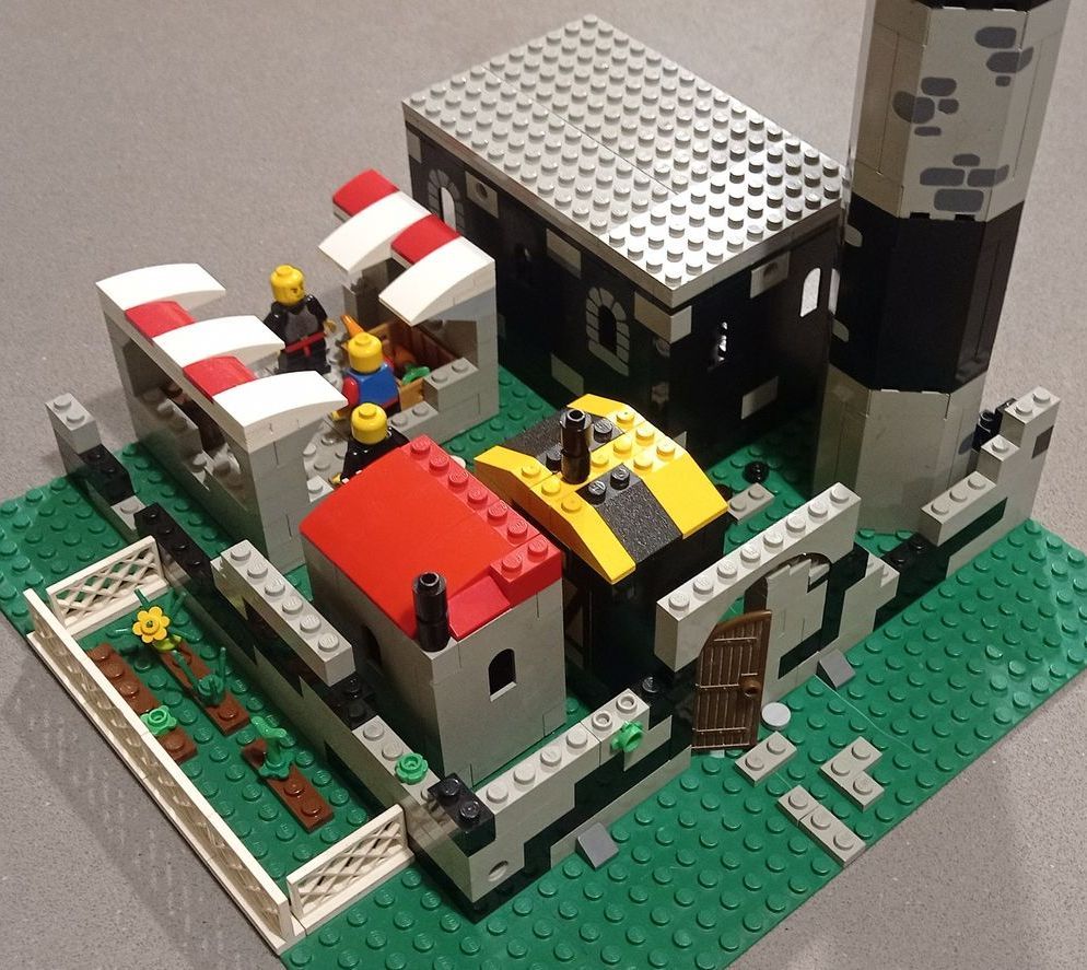A lego model of a castle with a red roof