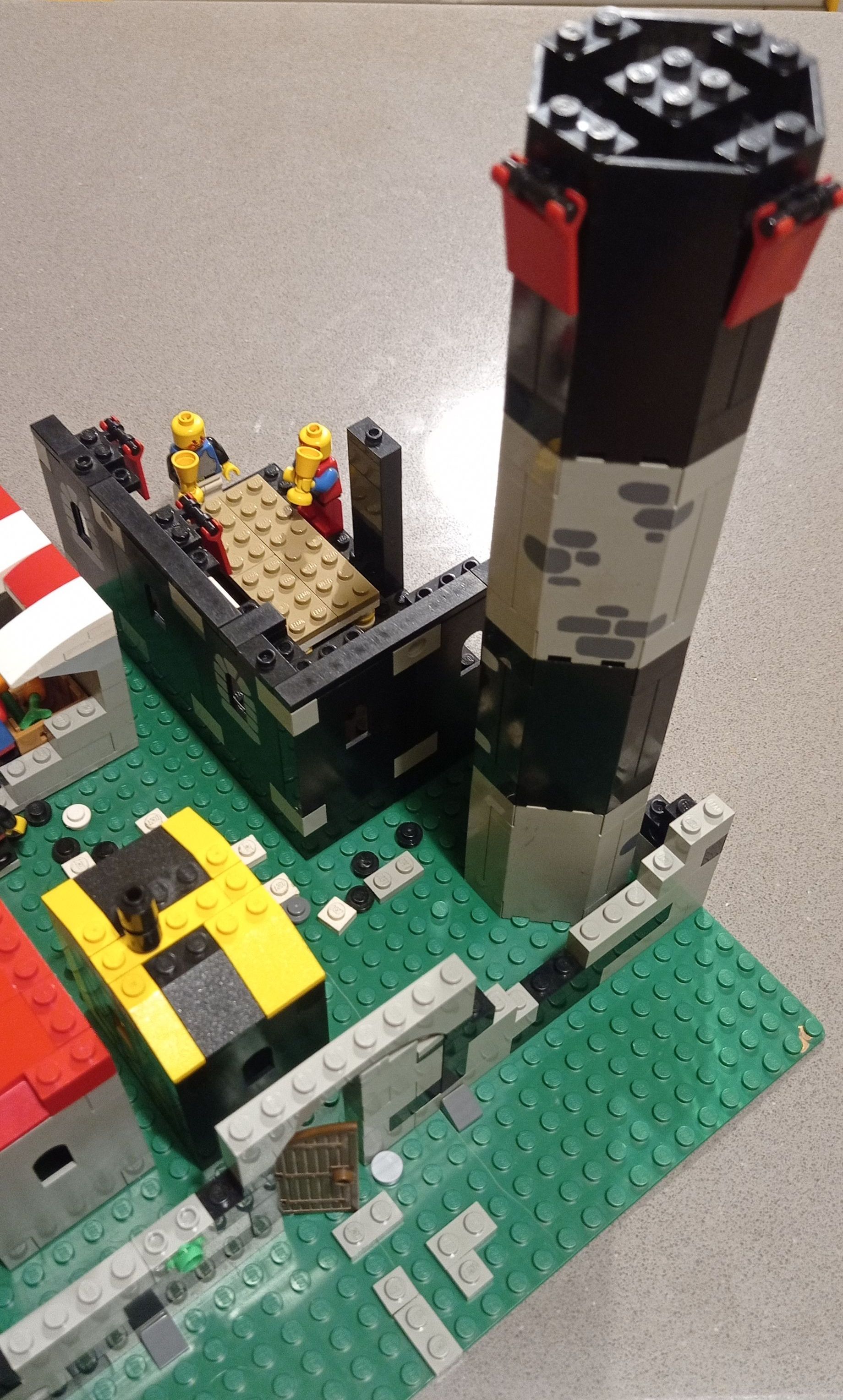 A lego lighthouse is sitting on top of a table.