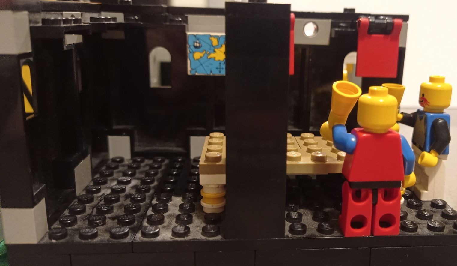 A group of lego figures are sitting around a table