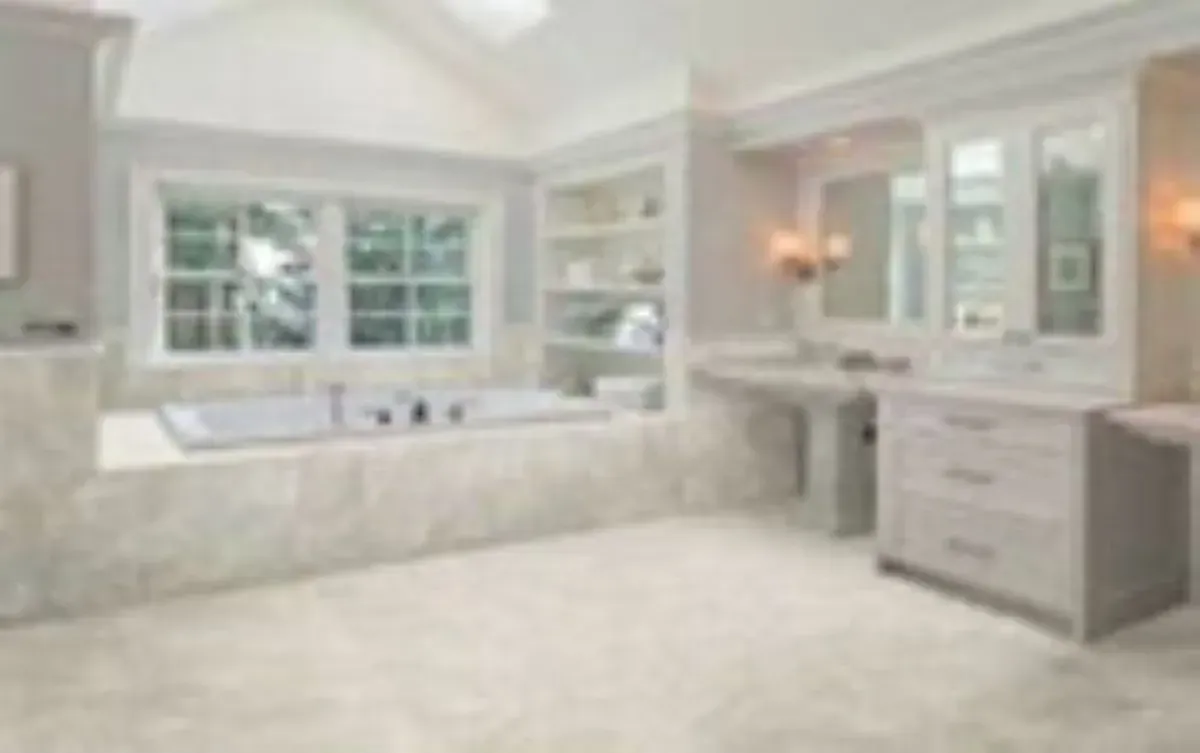 A bathroom with a tub , sink and mirrors.