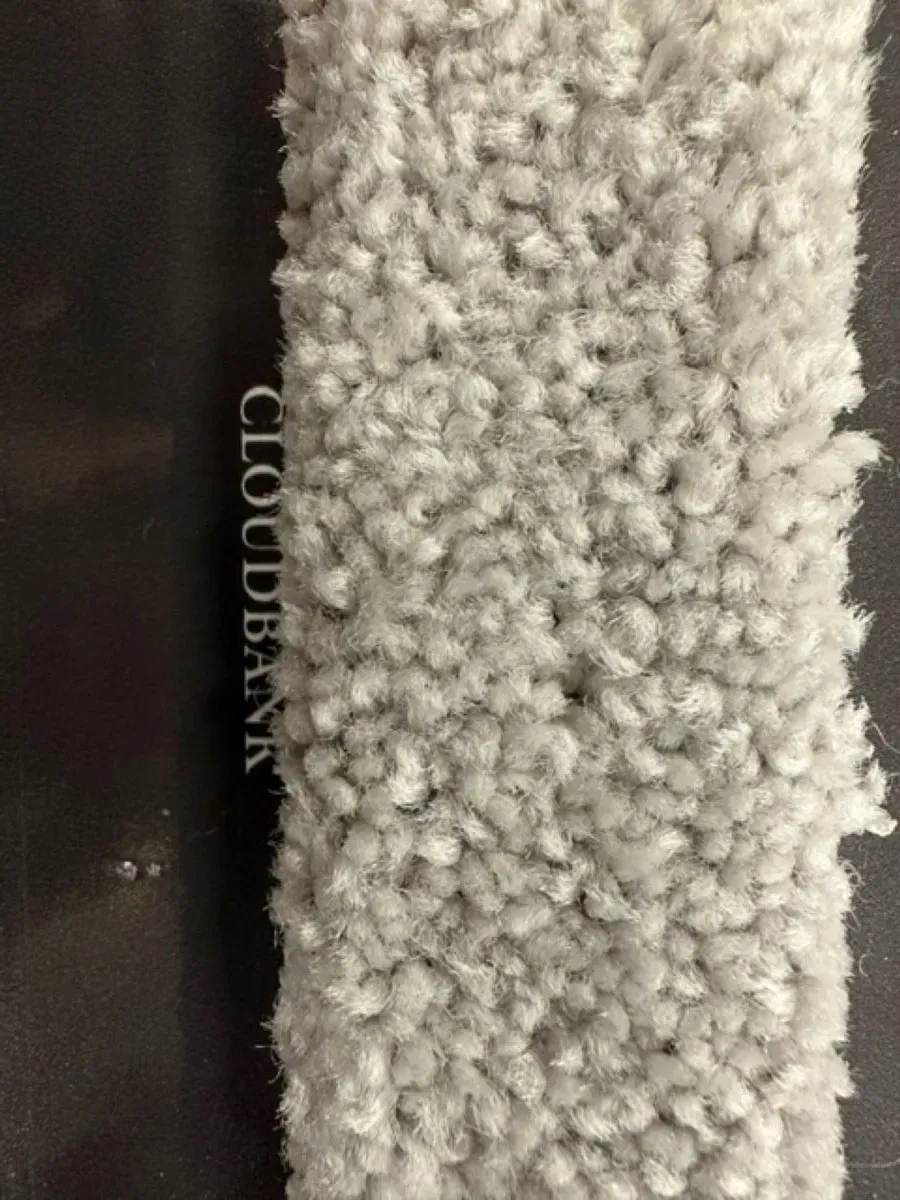 A close up of a piece of white carpet on a table.