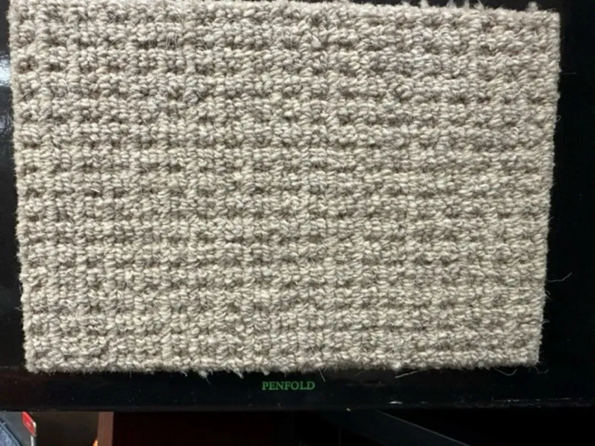 A piece of carpet is sitting on top of a black table.