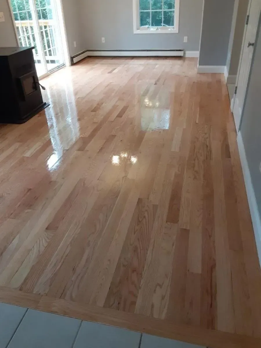 A living room with hardwood floors and a fireplace.