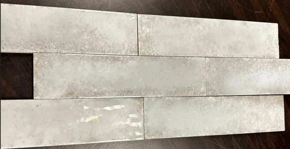 A stack of white tiles sitting on top of a wooden table.