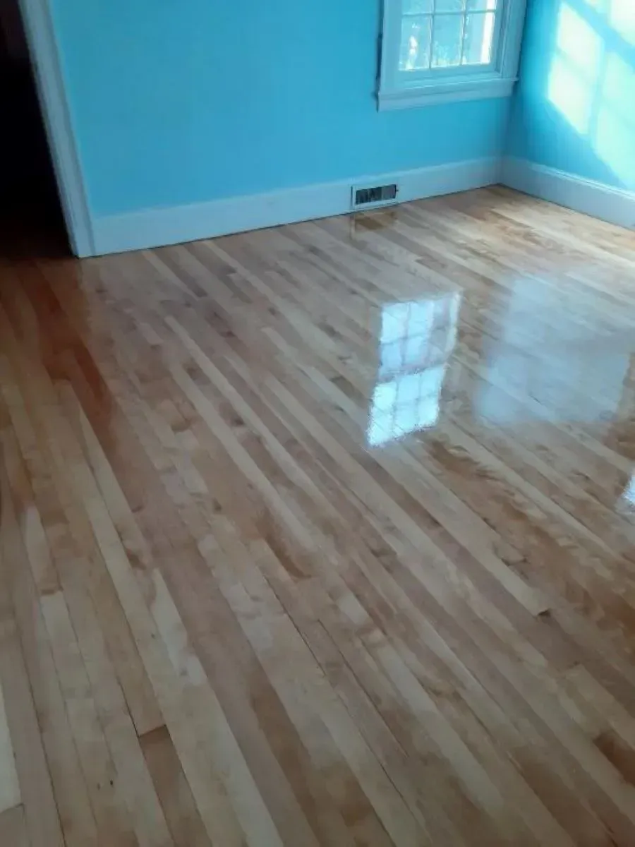 A room with a wooden floor and blue walls.