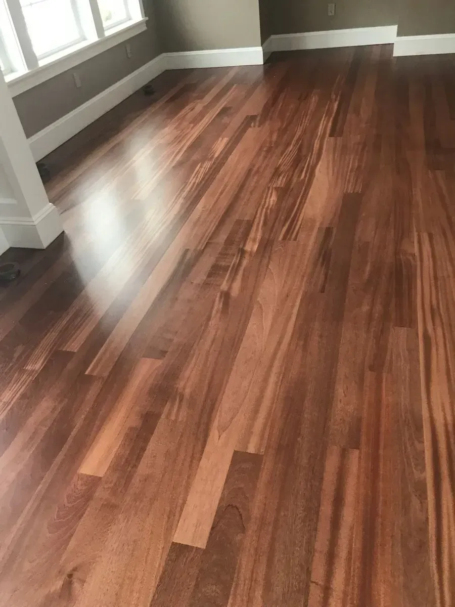 A close up of a wooden floor in a living room.