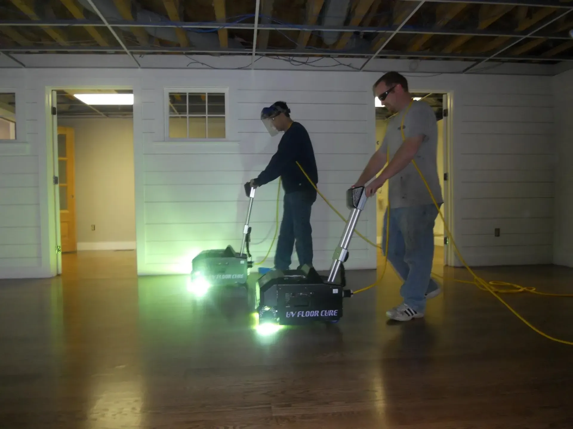 Two men are working on a machine that says ' a ' on it
