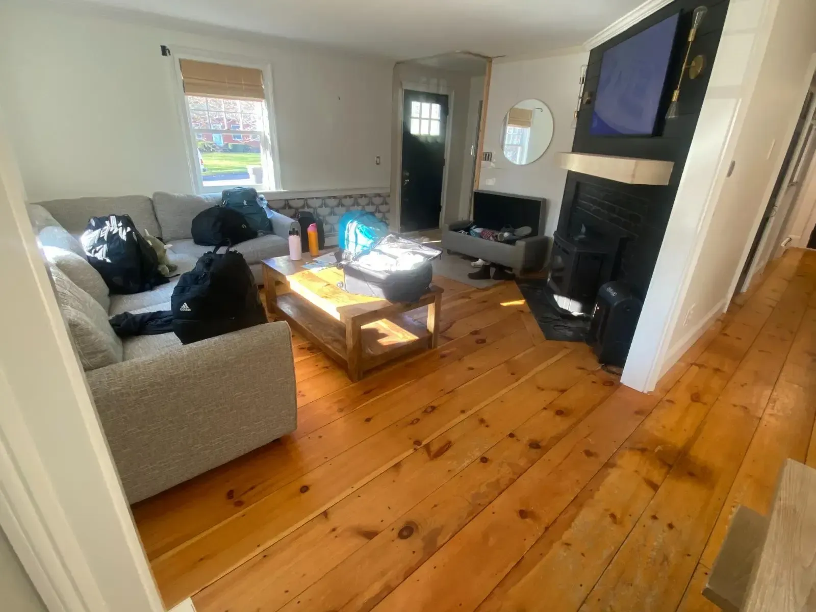A living room with a couch , coffee table , fireplace and television.