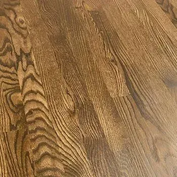 A close up of a wooden floor with a grain pattern.