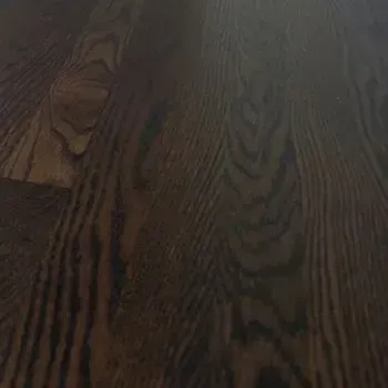 A close up of a wooden floor with a grain pattern.