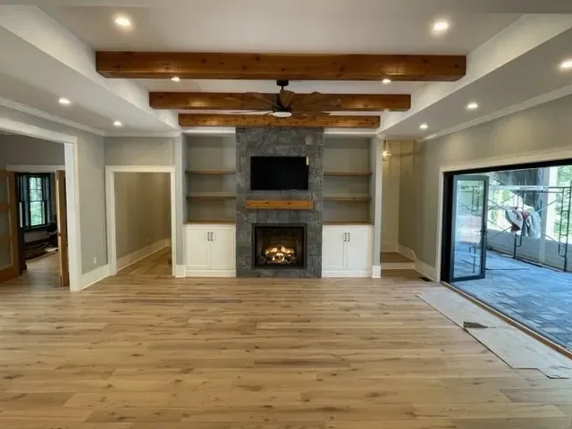 A living room with a fireplace and a flat screen tv