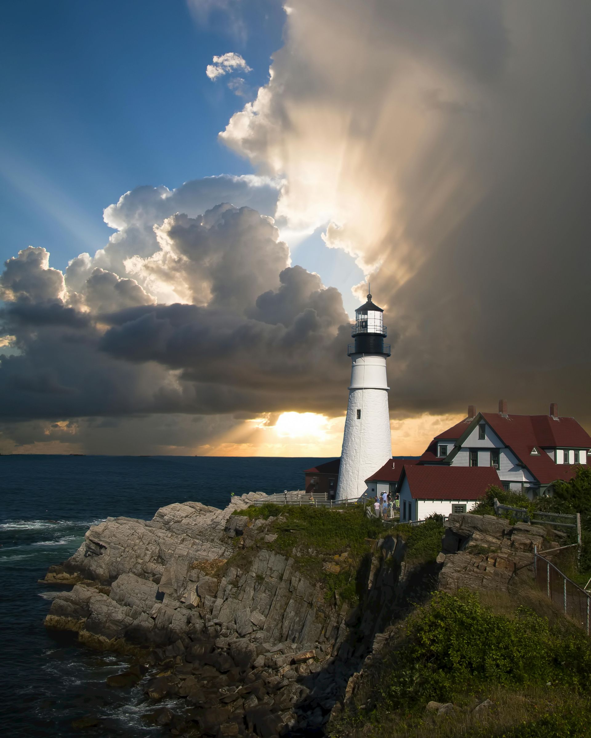 A lighthouse on a rocky cliff overlooking the ocean