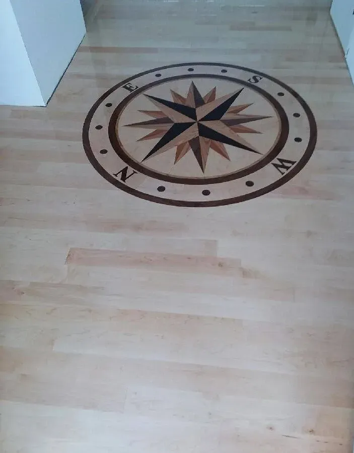 A wooden floor with a compass on it