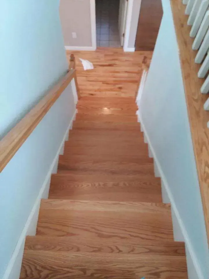 A set of wooden stairs leading up to a second floor in a house.