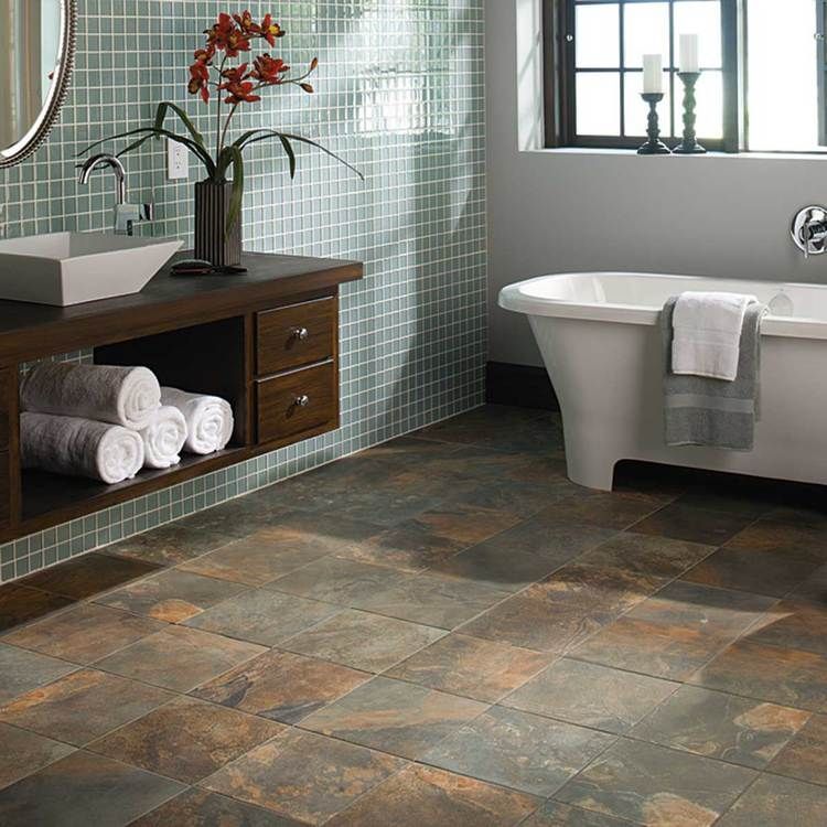 A bathroom with a tub , sink and mirror.