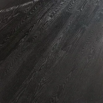 A close up of a black wooden floor.