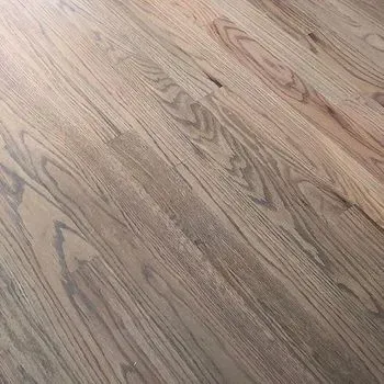 A close up of a wooden floor in a room.