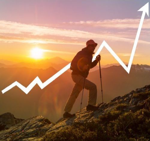 A man hiking up a mountain with a sales growth chart behind him