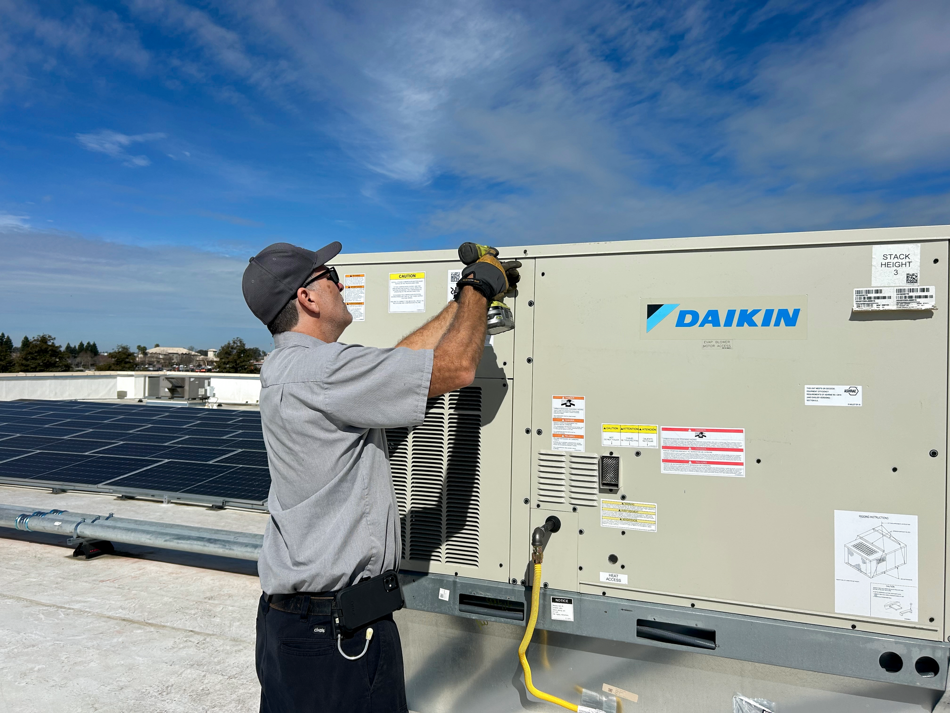 Worker Working on an Air Conditioner