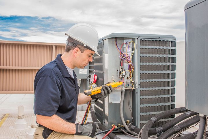 Worker Working on an Air Conditioner