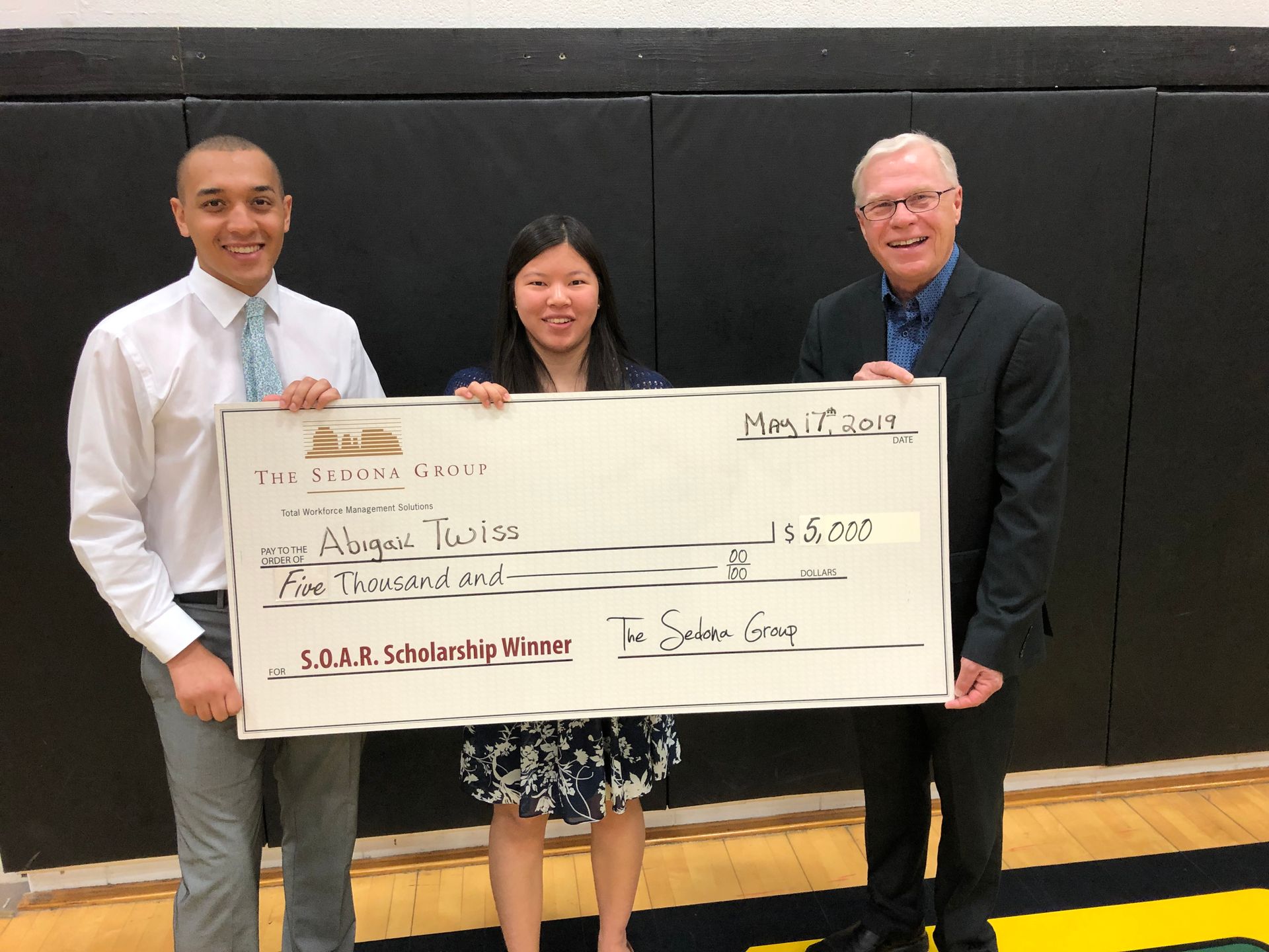 High school senior being presented with a Sedona SOAR scholarship check.
