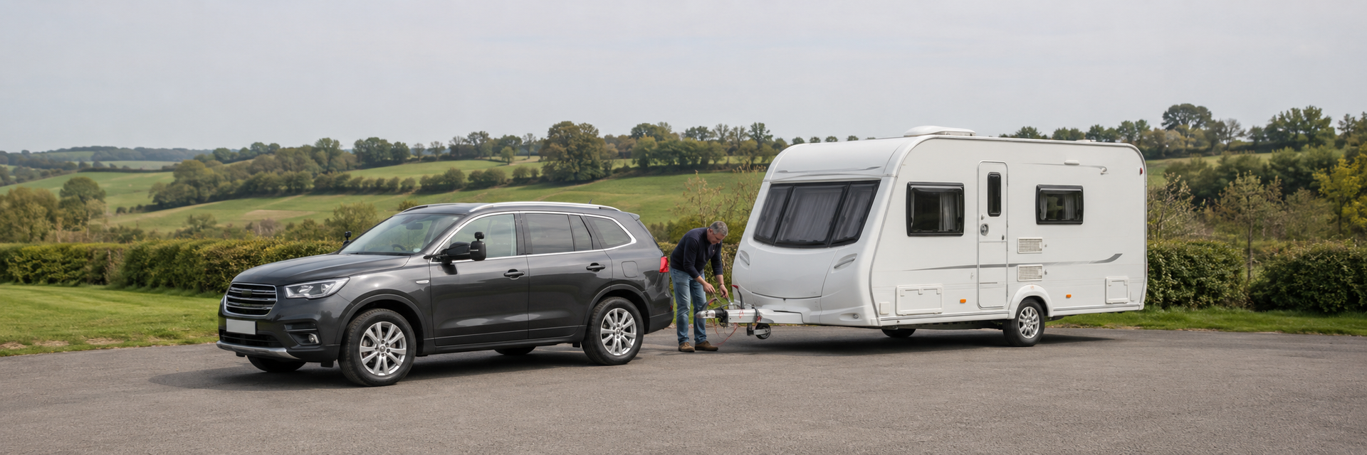 Caravan owner checking the hitch and breakaway cable before towing