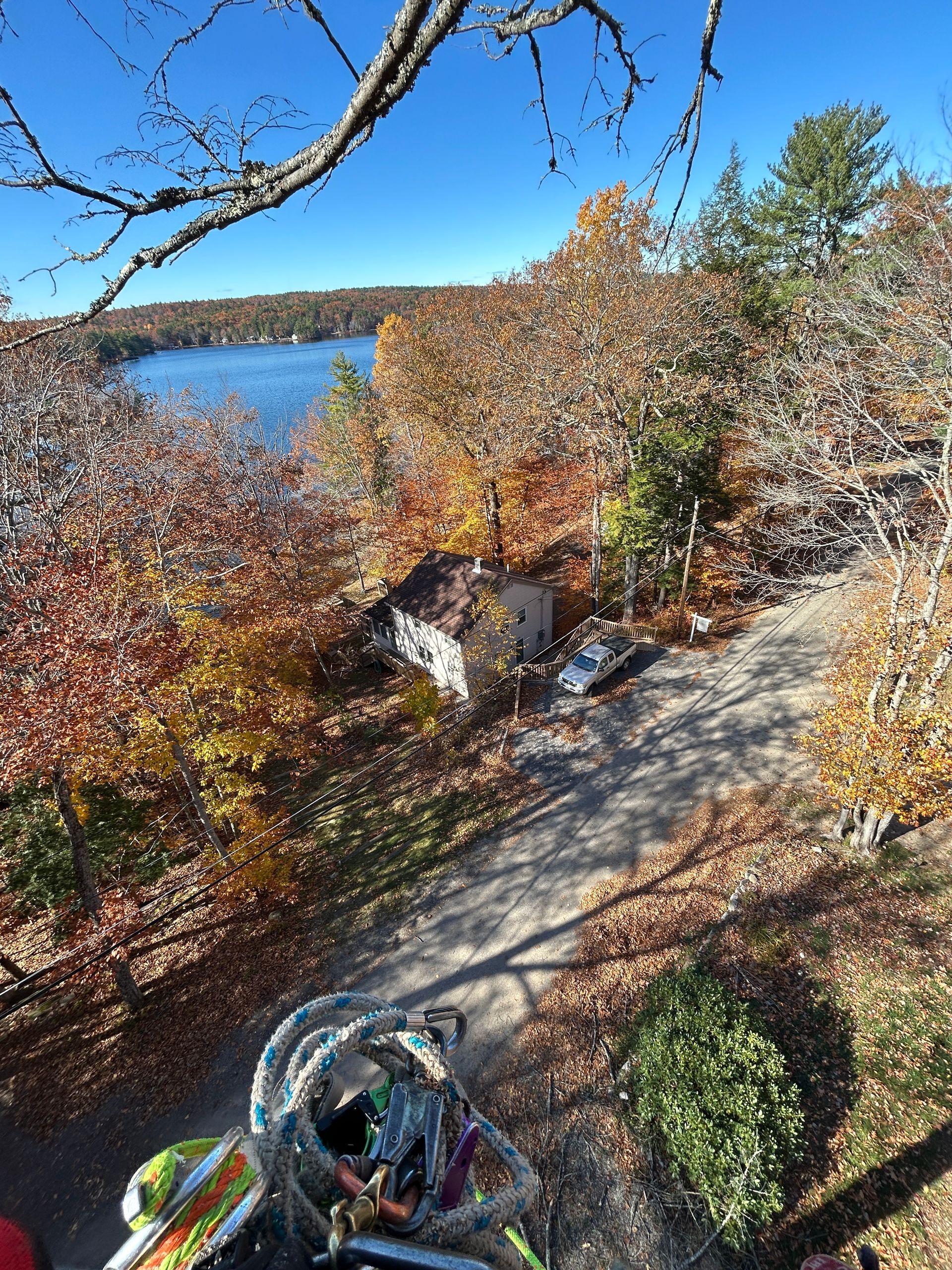 Bicycle on a gravel path overlooking a lake with autumn trees and a clear blue sky