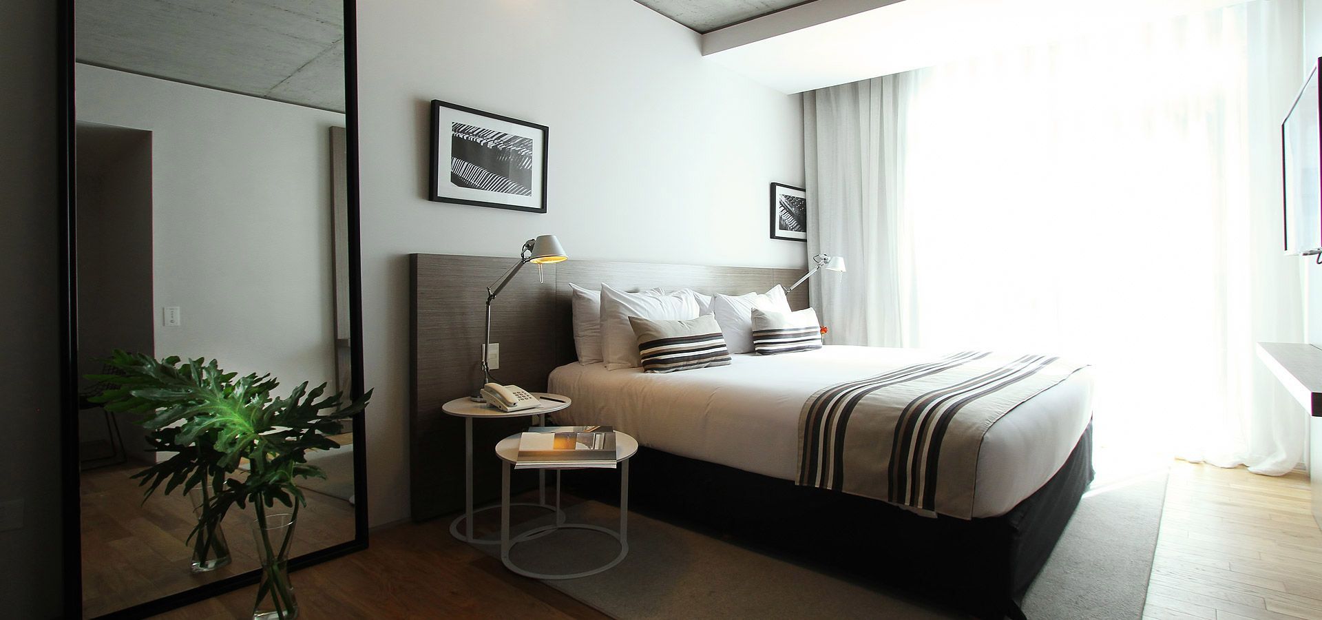 Un dormitorio con una cama grande y un espejo grande