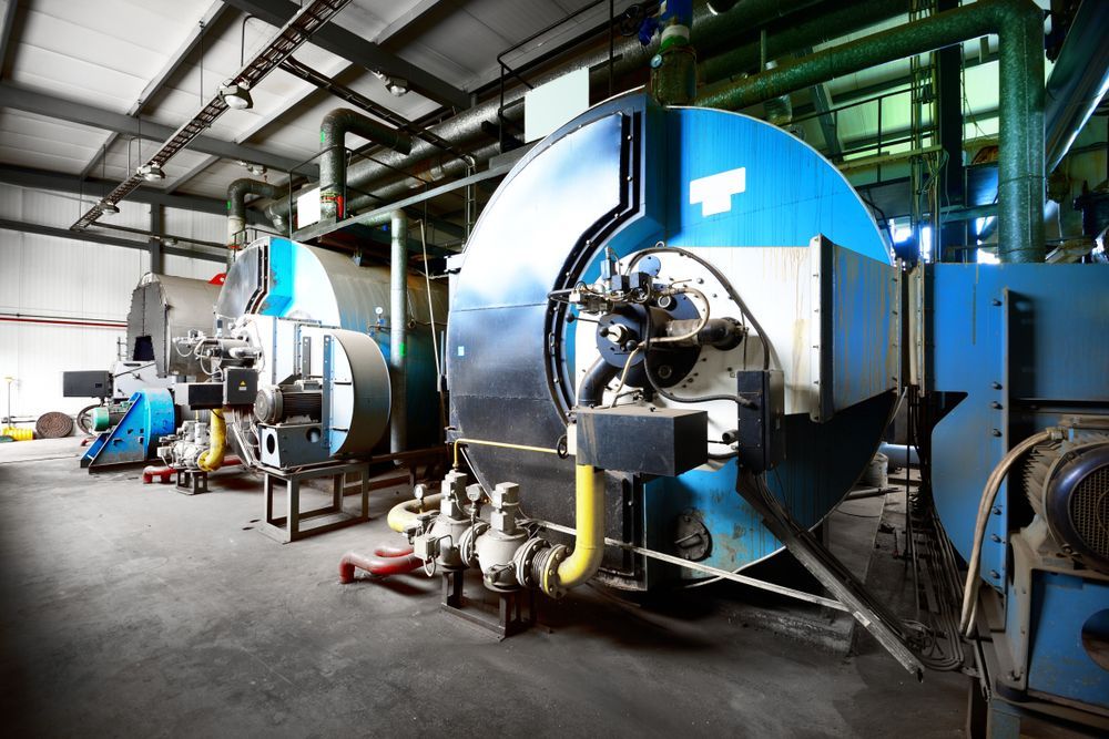 A Row of Boilers Are Lined Up in a Factory — J & N Plumbing Pty Ltd In Kootingal, NSW