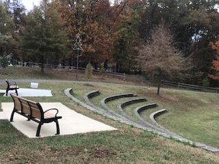 A park with a bench and stairs in the middle of it.