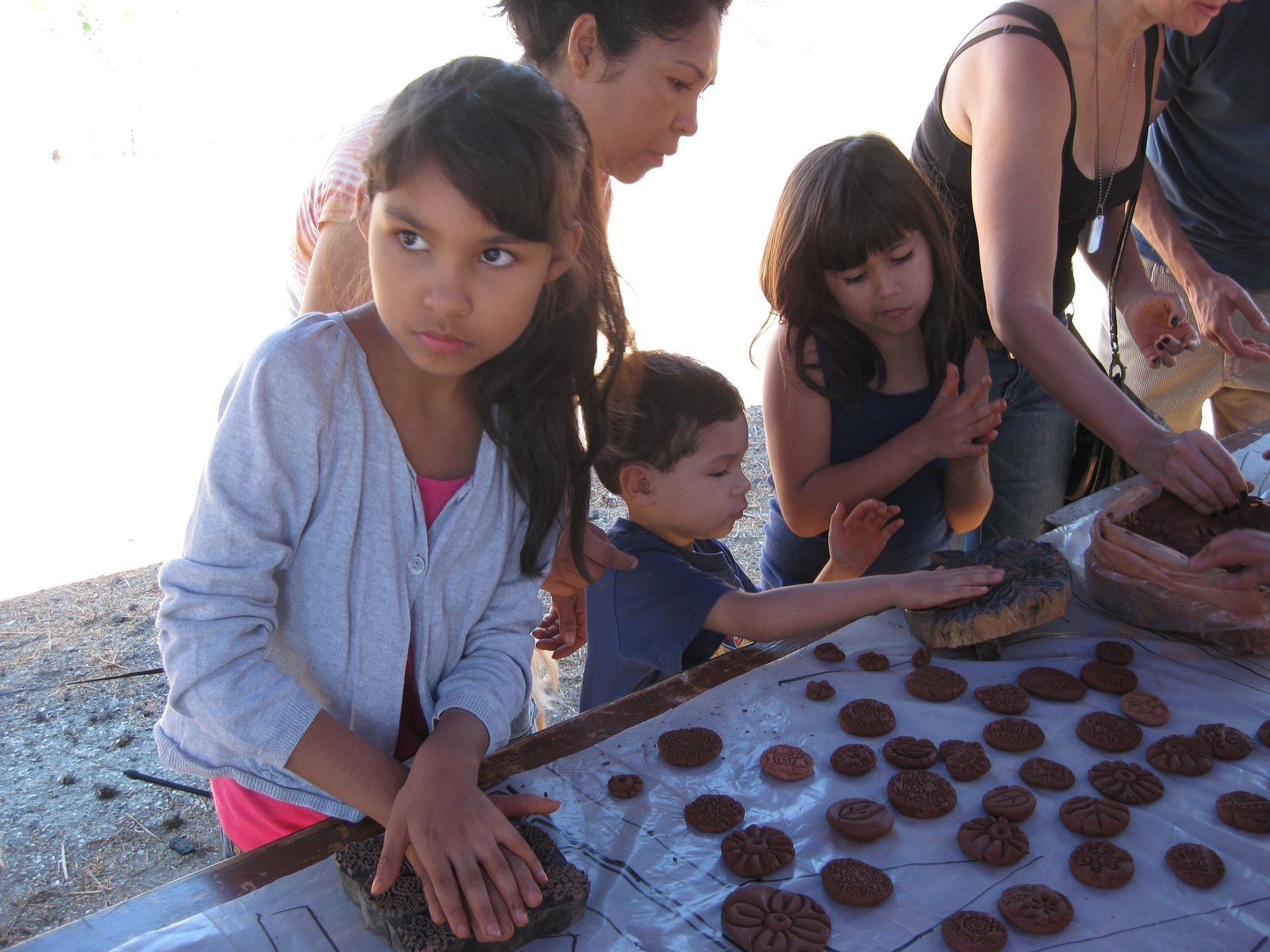 A group of children are playing with clay on a table.