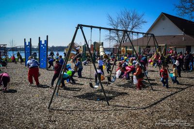 A group of children are playing on swings in a playground.