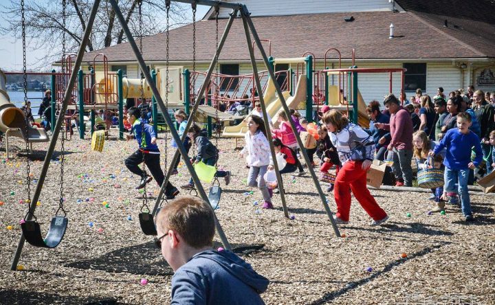 A group of children are playing on swings in a playground.