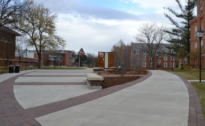 A brick walkway leading to a building on a cloudy day