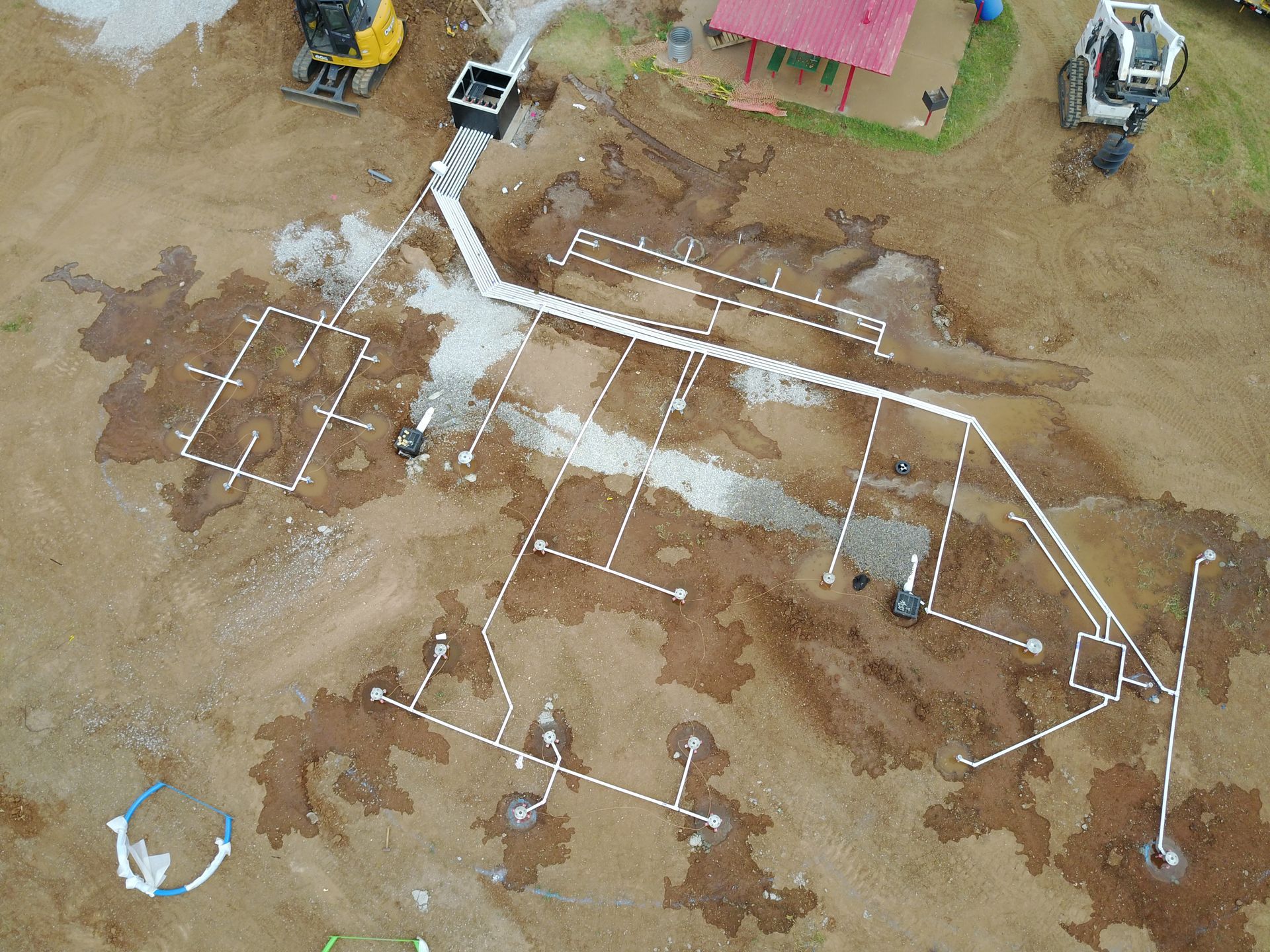 An aerial view of a construction site with a drawing on the ground.