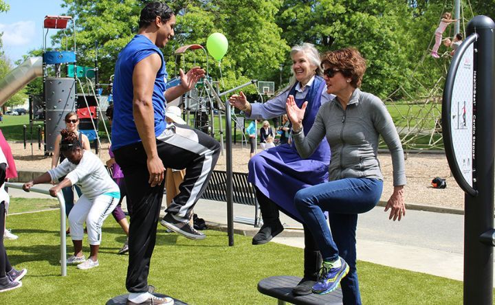 A group of people are playing a game in a park.