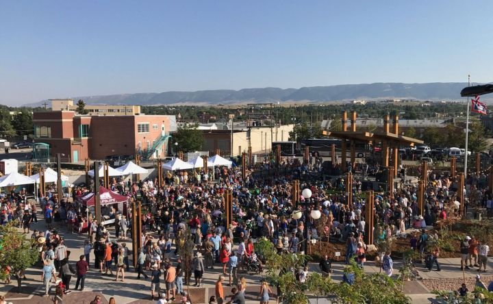 A large crowd of people are gathered in a park.