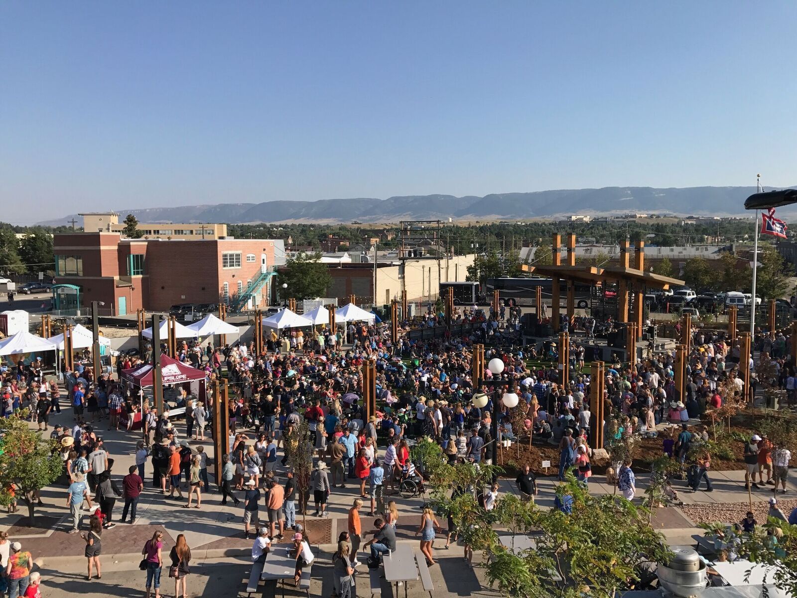 A large crowd of people are gathered in a park.