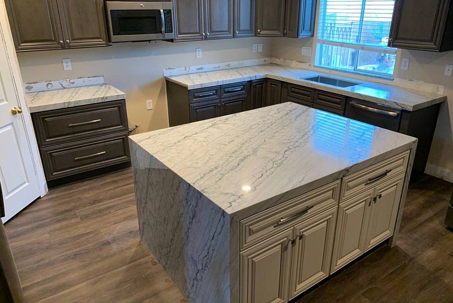 A kitchen with a large island in the middle of it.