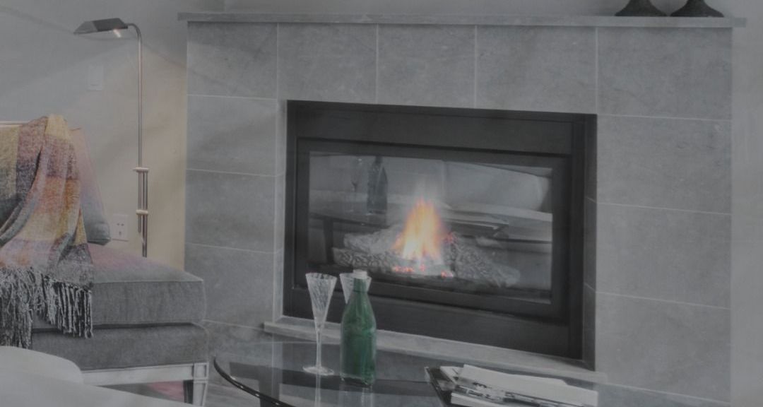 Elegant custom stone fireplace with a sleek design, featuring a glass insert and ambient lighting.