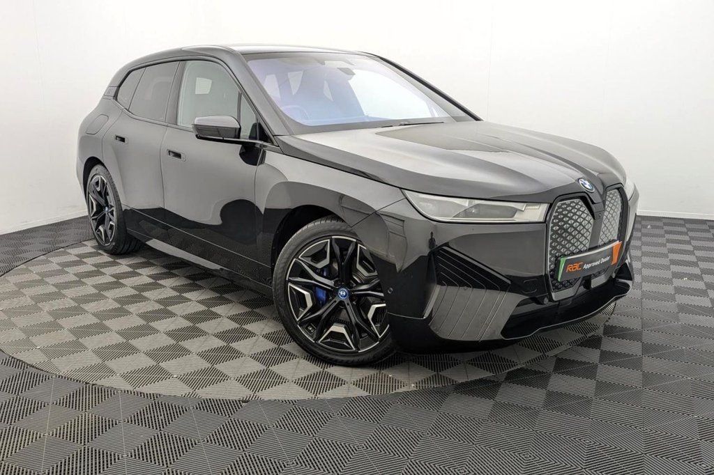 Black SUV on a patterned showroom floor, shown from the front-left side.