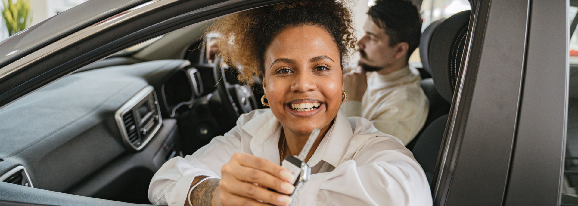 Picture of a happy person in a car. 