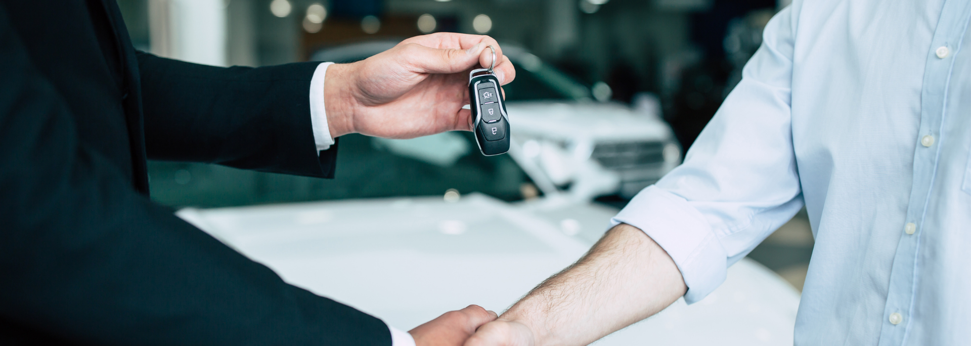 Picture of someone handing over car keys. Picture of someone handing over car keys.