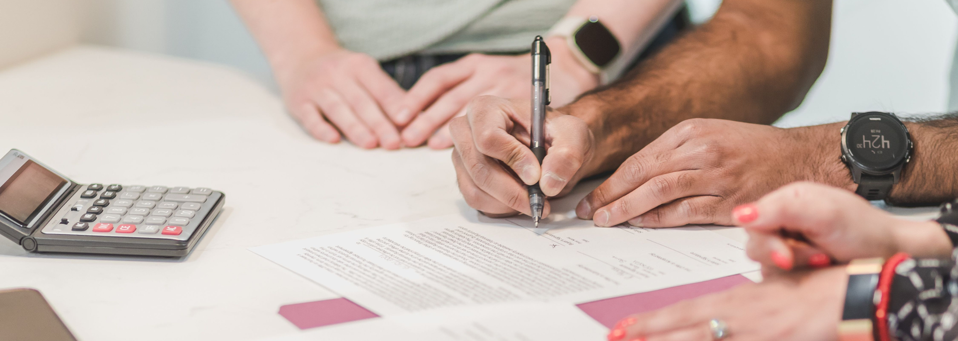 Picture of someone signing a document. 