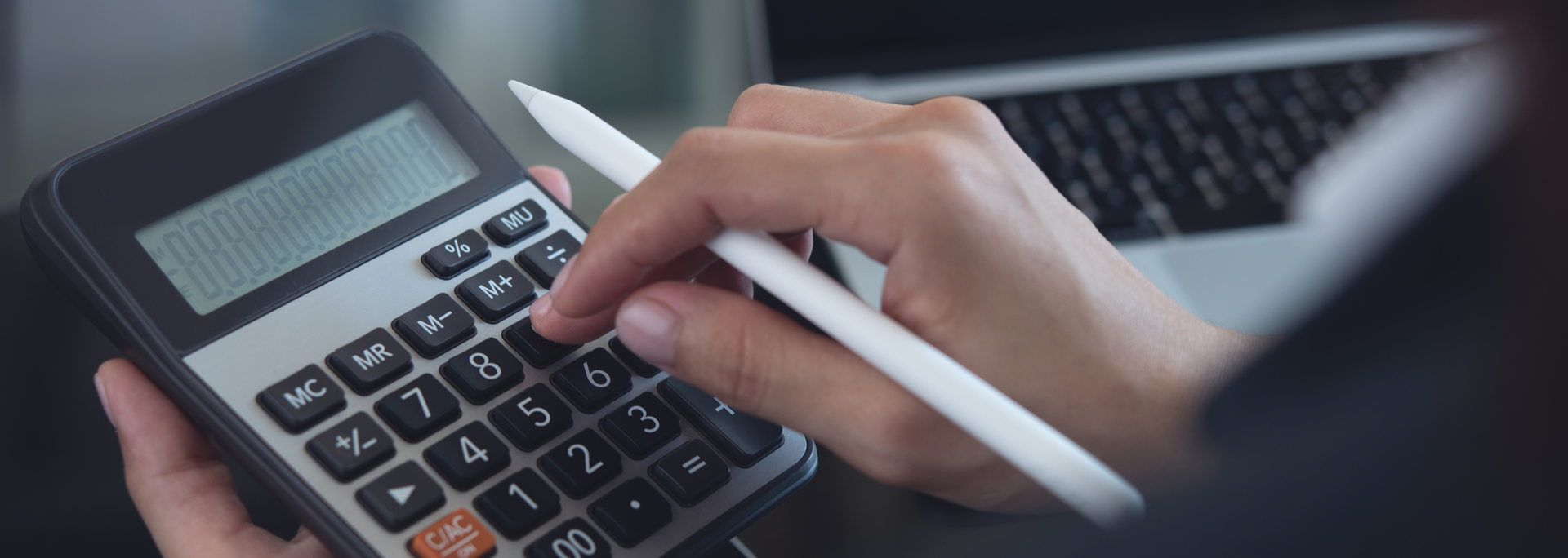 Picture of someone using a calculator. Picture of someone using a calculator.