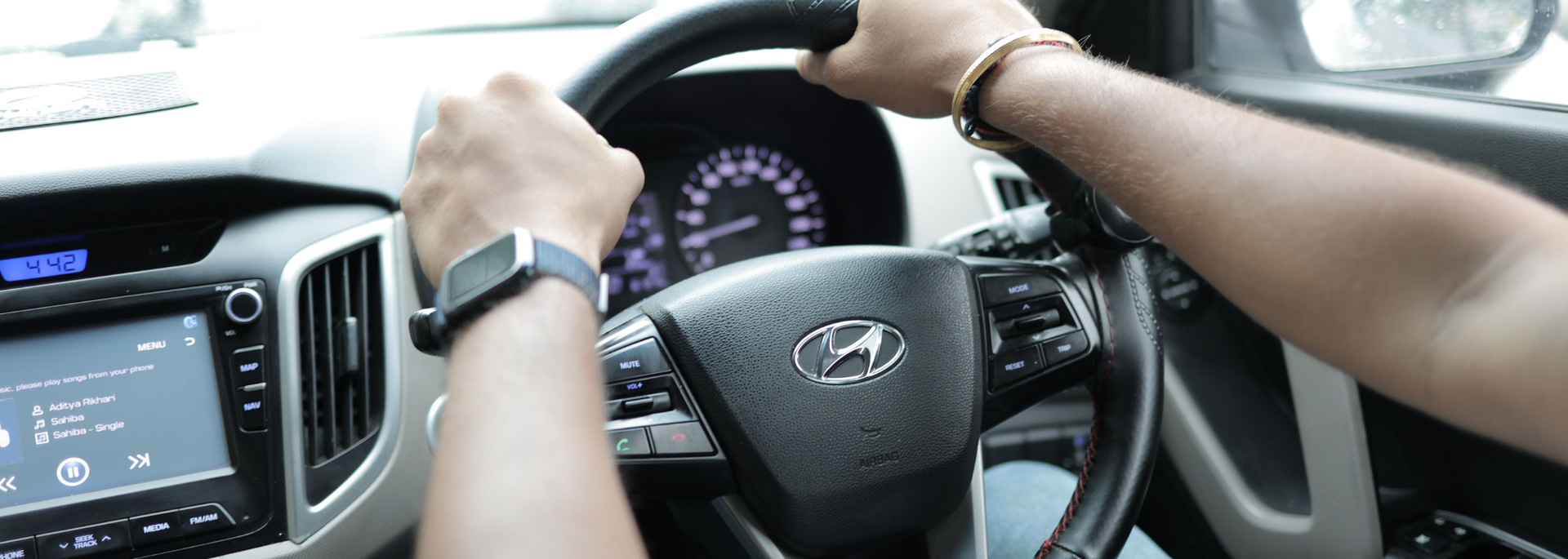 Picture of someone driving a car. 