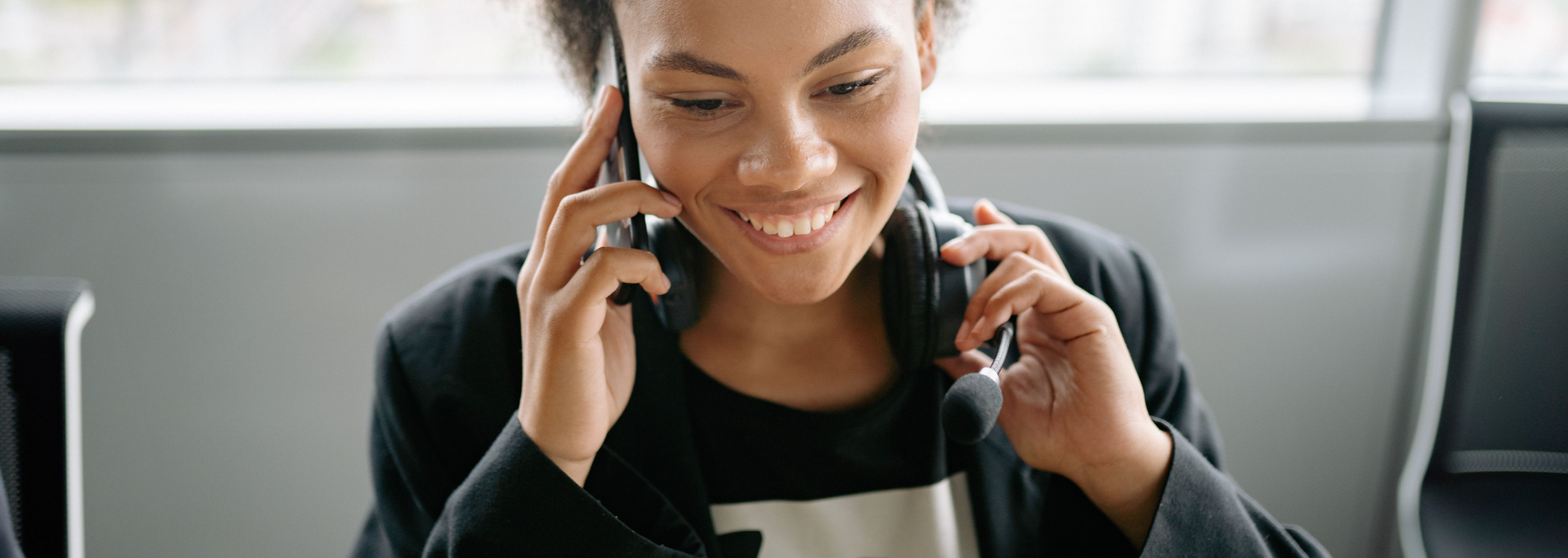 Picture of someone looking happy on the phone. 