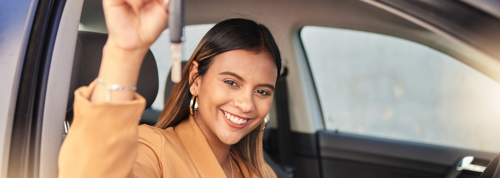 Picture of a woman looking happy in a car. Picture of a woman looking happy in a car.
