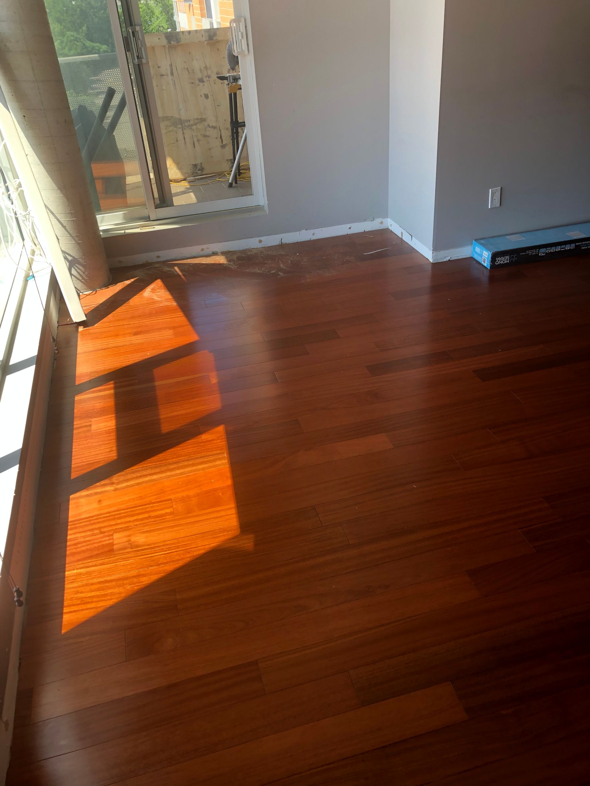Une pièce avec du parquet et une fenêtre.